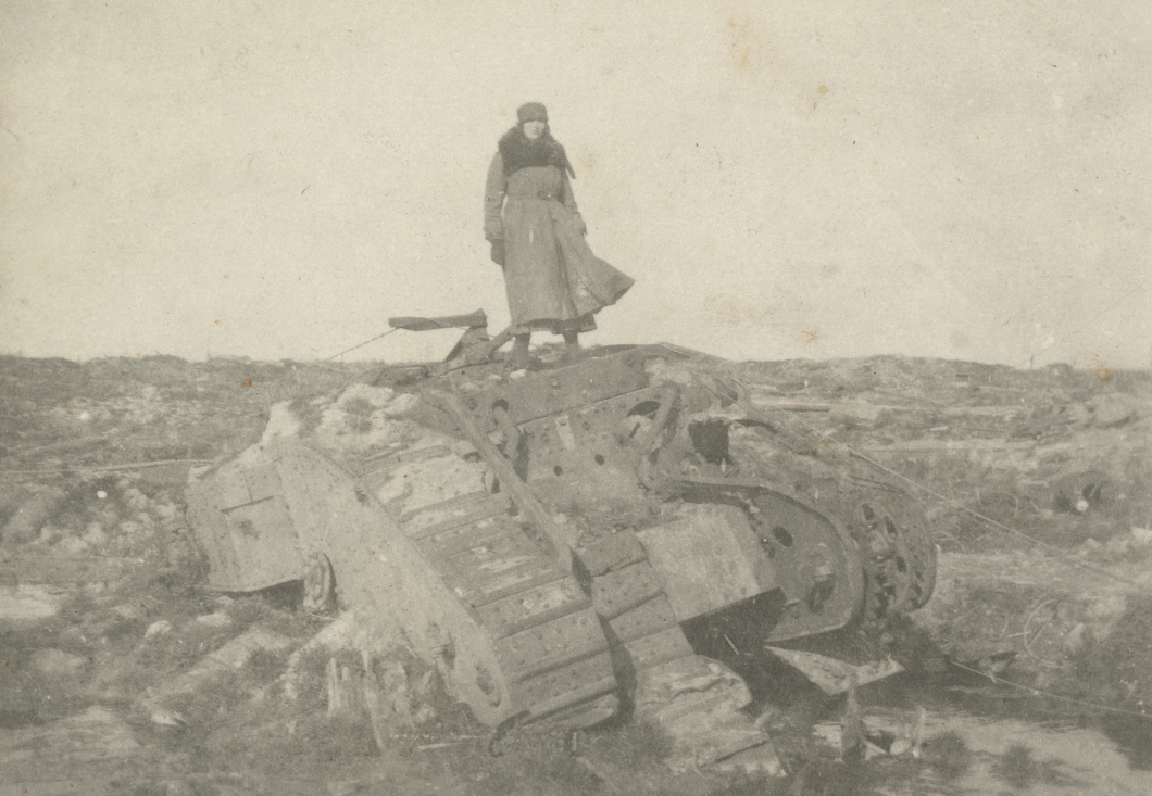 Woman in long coat standing on tank